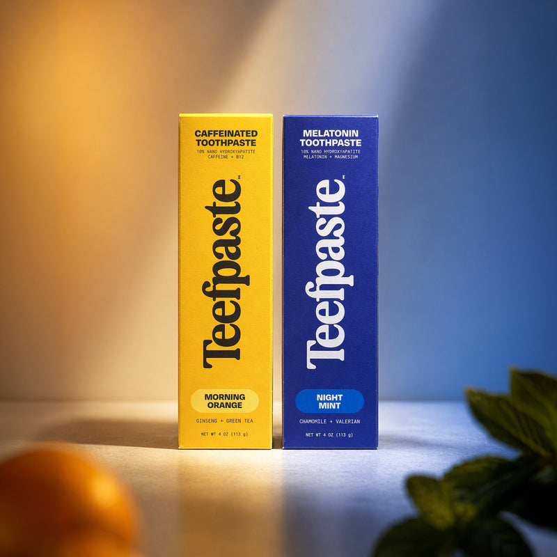 Two boxes of Teefpaste toothpaste, one yellow and one blue, on a gradient background.
